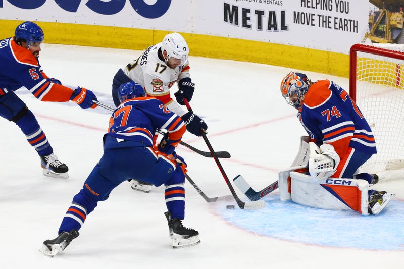 Jun 15, 2024; Edmonton, Alberta, CAN; Florida Panthers center Evan Rodrigues (17) battles Edmonton Oilers defenseman Brett Kulak (27) and goaltender Stuart Skinner (74) for the puck in the first period in game four of the 2024 Stanley Cup Final at Rogers Place. Mandatory Credit: Sergei Belski-USA TODAY Sports