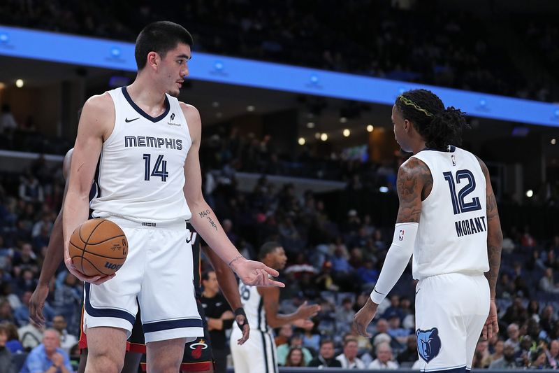 MEMPHIS, TENNESSEE - OCTOBER 18: Zach Edey #14 of the Memphis Grizzlies and Ja Morant interact during the first half against the Miami Heat at FedExForum on October 18, 2024 in Memphis, Tennessee. NOTE TO USER: User expressly acknowledges and agrees that, by downloading and or using this photograph, User is consenting to the terms and conditions of the Getty Images License Agreement. (Photo by Justin Ford/Getty Images)