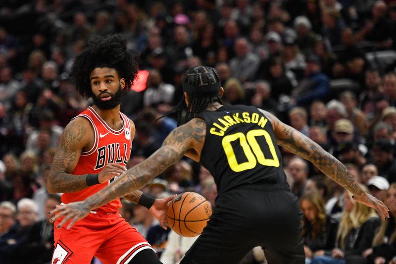 SALT LAKE CITY, UTAH - MARCH 06: Coby White #0 of the Chicago Bulls looks to drive around Jordan Clarkson #00 of the Utah Jazz during the first half of a game at Delta Center on March 06, 2024 in Salt Lake City, Utah. NOTE TO USER: User expressly acknowledges and agrees that, by downloading and or using this photograph, User is consenting to the terms and conditions of the Getty Images License Agreement.  (Photo by Alex Goodlett/Getty Images)