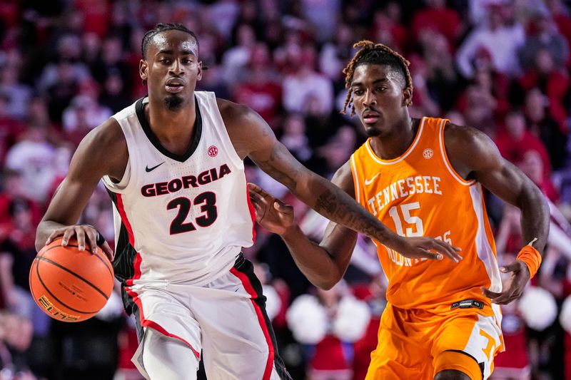 Jan 13, 2024; Athens, Georgia, USA; Georgia Bulldogs forward Jalen DeLoach (23) dribbles past Tennessee Volunteers guard Jahmai Mashack (15) during the second half at Stegeman Coliseum. Mandatory Credit: Dale Zanine-USA TODAY Sports