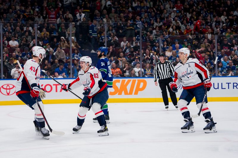 Mar 16, 2024; Vancouver, British Columbia, CAN; Washington Capitals forward Tom Wilson (43) and forward Ivan Miroshnichenko (63) and defenseman John Carlson (74) celebrate Wilson’s goal against the Vancouver Canucks in the second period at Rogers Arena. Mandatory Credit: Bob Frid-USA TODAY Sports