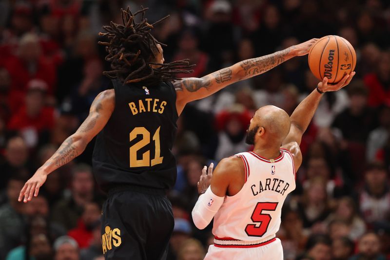 CHICAGO, ILLINOIS - DECEMBER 23: Emoni Bates #21 of the Cleveland Cavaliers blocks a shot by Jevon Carter #5 of the Chicago Bulls during the first half at the United Center on December 23, 2023 in Chicago, Illinois. NOTE TO USER: User expressly acknowledges and agrees that, by downloading and or using this photograph, User is consenting to the terms and conditions of the Getty Images License Agreement.  (Photo by Michael Reaves/Getty Images)