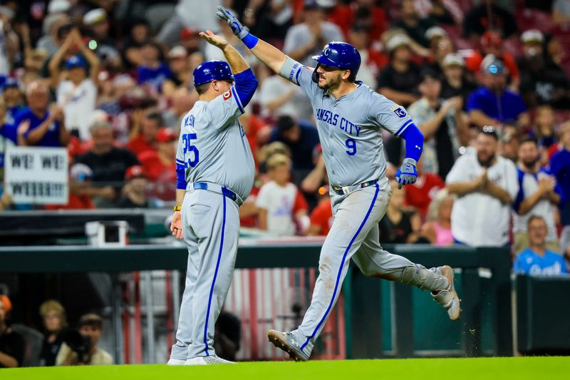 Aug 16, 2024; Cincinnati, Ohio, USA; Kansas City Royals first baseman Vinnie Pasquantino (9) high fives third base coach Vance Wilson (25) after hitting a three-run home run in the ninth inning against the Cincinnati Reds at Great American Ball Park. Mandatory Credit: Katie Stratman-USA TODAY Sports