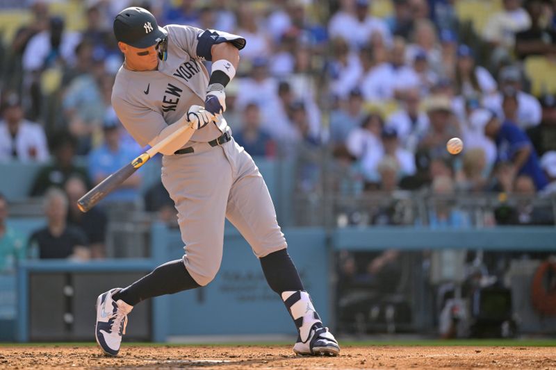 May 31, 2025; Los Angeles, California, USA;  New York Yankees right fielder Aaron Judge (99) hits a solo home run in the furth inning against the Los Angeles Dodgers at Dodger Stadium. Mandatory Credit: Jayne Kamin-Oncea-Imagn Images