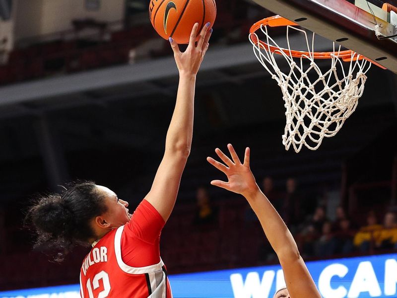 Feb 8, 2024; Minneapolis, Minnesota, USA; Ohio State Buckeyes guard Celeste Taylor (12) shoots as Minnesota Golden Gophers guard Maggie Czinano (5) defends during the second half at Williams Arena. Mandatory Credit: Matt Krohn-USA TODAY Sports