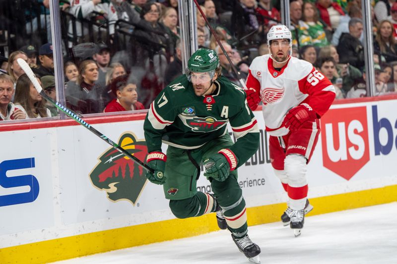 Feb 25, 2025; Saint Paul, Minnesota, USA; Minnesota Wild left wing Marcus Foligno (17) chases a loose puck against Detroit Red Wings in the first period second at Xcel Energy Center. Mandatory Credit: Matt Blewett-Imagn Images