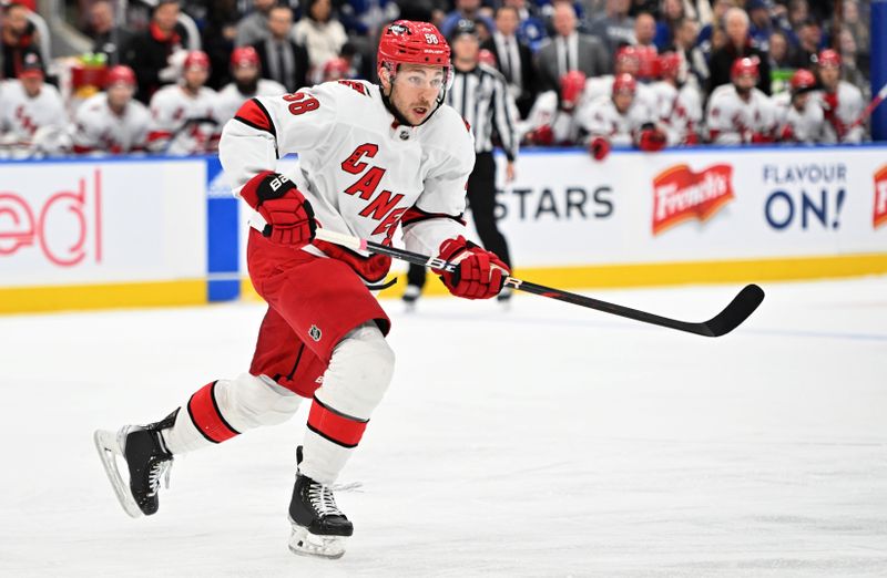 Dec 30, 2023; Toronto, Ontario, CAN; Carolina Hurricanes forward Michael Bunting (58) pursues the play against the Toronto Maple Leafs in the first period at Scotiabank Arena. Mandatory Credit: Dan Hamilton-USA TODAY Sports