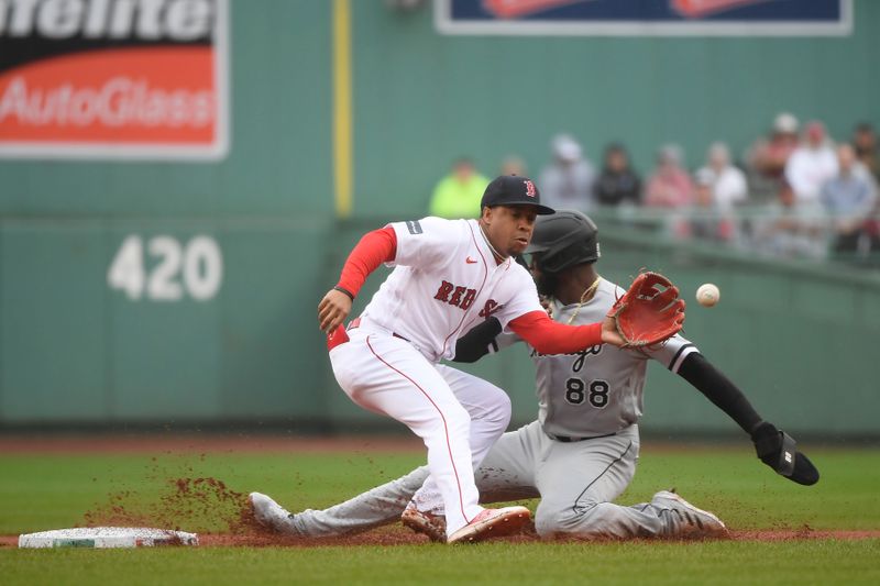 Sep 24, 2023; Boston, Massachusetts, USA; Chicago White Sox center fielder Luis Robert Jr. (88) slides safely past Boston Red Sox second baseman Enmanuel Valdez (47) during the first inning at Fenway Park. Mandatory Credit: Bob DeChiara-USA TODAY Sports