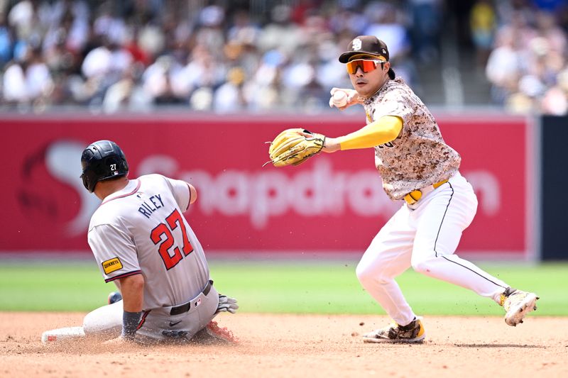 Jul 14, 2024; San Diego, California, USA; San Diego Padres shortstop Ha-Seong Kim (7) forces out Atlanta Braves third baseman Austin Riley (27) at second base during the sixth inning at Petco Park. Mandatory Credit: Orlando Ramirez-USA TODAY Sports