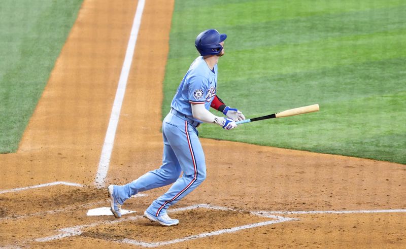 Jul 21, 2024; Arlington, Texas, USA; Texas Rangers catcher Jonah Heim (28) hits a three run home run during the fourth inning against the Baltimore Orioles at Globe Life Field. Mandatory Credit: Kevin Jairaj-USA TODAY Sports