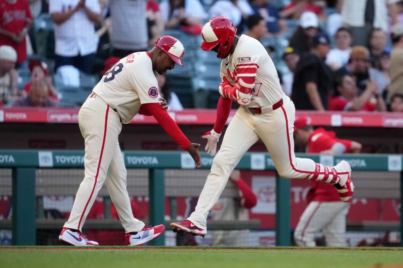 May 8, 2025; Anaheim, California, USA; Los Angeles Angels right fielder Jo Adell (7) is congratulated by third base coach Bo Porter (88) after hitting a home run in the second inning against the Toronto Blue Jays at Angel Stadium. Mandatory Credit: Kirby Lee-Imagn Images