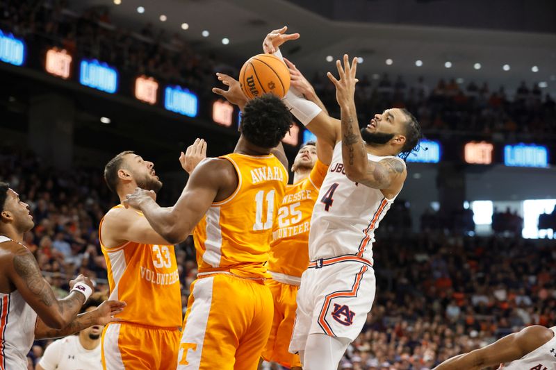 Mar 4, 2023; Auburn, Alabama, USA;  TAuburn Tigers forward Johni Broome (4) fights for a rebound against Tennessee Volunteers forwards Uros Plavsic (33), Tobe Awaka (11) and guard Jahmai Magainsthack (15) during the first half at Neville Arena. Mandatory Credit: John Reed-USA TODAY Sports