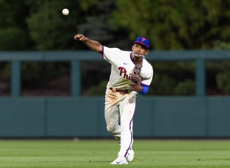 Aug 23, 2023; Philadelphia, Pennsylvania, USA; Philadelphia Phillies center fielder Johan Rojas (18) throws for a double play after making a diving catch against the San Francisco Giants during the tenth inning at Citizens Bank Park. Mandatory Credit: Bill Streicher-USA TODAY Sports