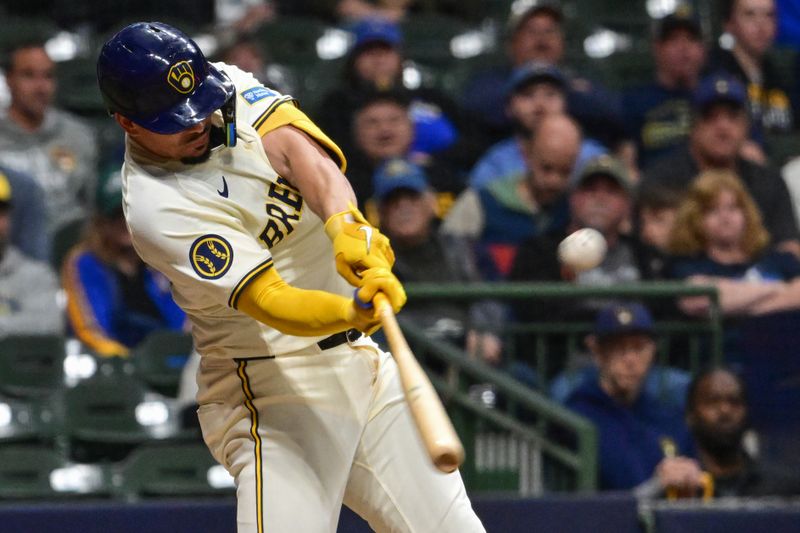 May 13, 2024; Milwaukee, Wisconsin, USA; Milwaukee Brewers shortstop Willy Adames (27) hits a double to drive in two run in the seventh inning against the Pittsburgh Pirates at American Family Field. Mandatory Credit: Benny Sieu-USA TODAY Sports