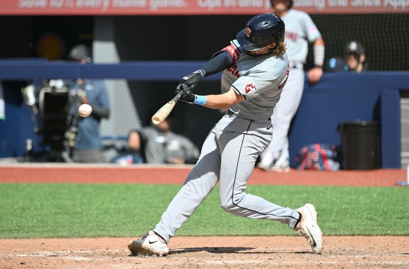 Jun 16, 2024; Toronto, Ontario, CAN;  Cleveland Guardians third baseman Daniel Schneemann (10) hits a single against the Toronto Blue Jays in the ninth inning at Rogers Centre. Mandatory Credit: Dan Hamilton-USA TODAY Sports