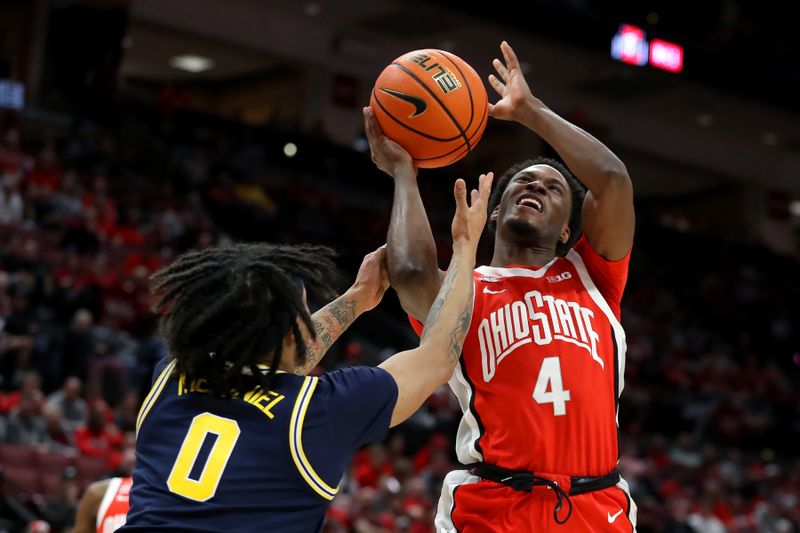 Mar 3, 2024; Columbus, Ohio, USA;  Ohio State Buckeyes guard Dale Bonner (4) is fouled by Michigan Wolverines guard Dug McDaniel (0) during the second half at Value City Arena. Mandatory Credit: Joseph Maiorana-USA TODAY Sports