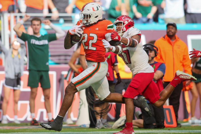 Nov 18, 2023; Miami Gardens, Florida, USA; Miami Hurricanes running back Mark Fletcher Jr. (22) runs with the football against Louisville Cardinals defensive back Devin Neal (27) during the third quarter at Hard Rock Stadium. Mandatory Credit: Sam Navarro-USA TODAY Sports