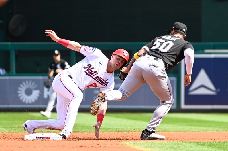 Sep 20, 2023; Washington, District of Columbia, USA; Washington Nationals right fielder Lane Thomas (28) is tagged out trying to steal second base by Chicago White Sox second baseman Lenyn Sosa (50) during the first inning at Nationals Park. Mandatory Credit: Brad Mills-USA TODAY Sports