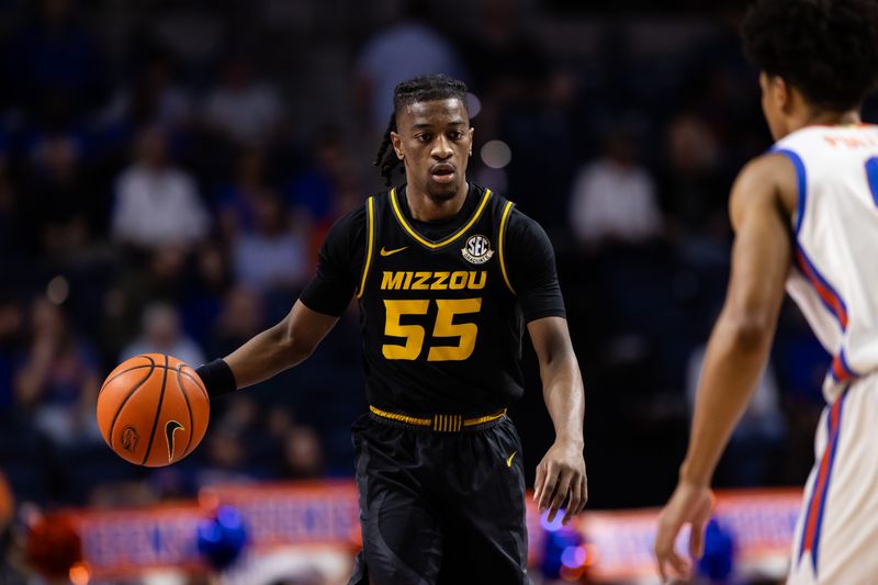 Feb 28, 2024; Gainesville, Florida, USA; Missouri Tigers guard Sean East II (55) dribbles the ball up the court towards Florida Gators guard Zyon Pullin (0) during the first half at Exactech Arena at the Stephen C. O'Connell Center. Mandatory Credit: Matt Pendleton-USA TODAY Sports