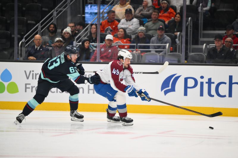 Dec 16, 2025; Seattle, Washington, USA; Colorado Avalanche defenseman Samuel Girard (49) advances the puck while defended by Seattle Kraken right wing Jacob Melanson (63) during the second period at Climate Pledge Arena. Mandatory Credit: Steven Bisig-Imagn Images