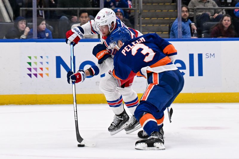 Apr 10, 2025; Elmont, New York, USA;  New York Islanders defenseman Adam Pelech (3) defends against New York Rangers left wing Will Cuylle (50) during the third period at UBS Arena. Mandatory Credit: Dennis Schneidler-Imagn Images