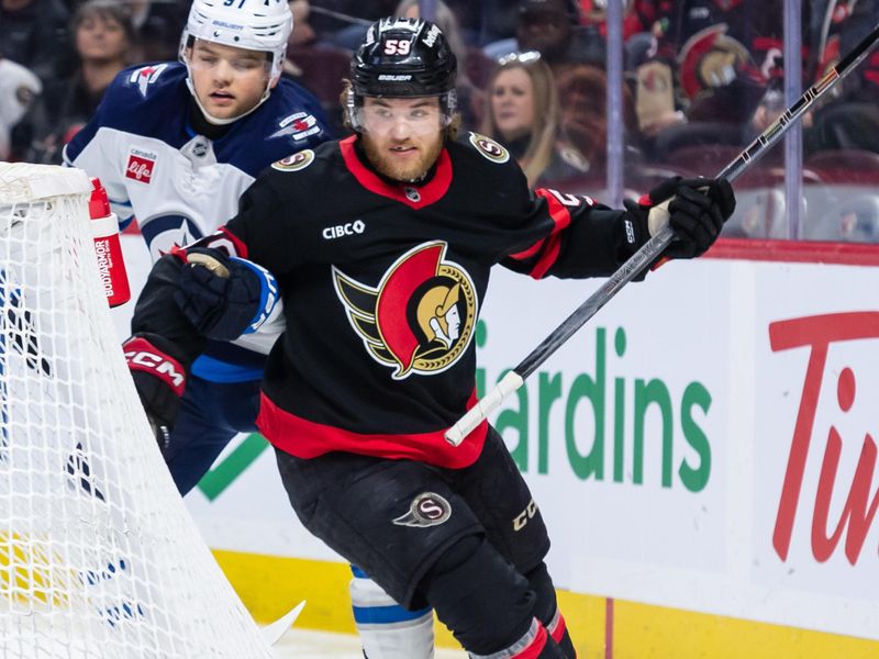 Feb 26, 2025; Ottawa, Ontario, CAN; Winnipeg Jets center Cole Perfetti (91) and Ottawa Senators left wing Angus Crookshank (59) chase the puck in the first period at the Canadian Tire Centre. Mandatory Credit: Marc DesRosiers-Imagn Images