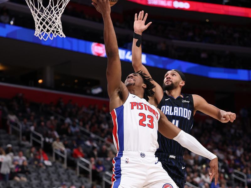 DETROIT, MICHIGAN - JANUARY 01: Jaden Ivey #23 of the Detroit Pistons drives to the basket against Jalen Suggs #4 of the Orlando Magic during the second half at Little Caesars Arena on January 01, 2025 in Detroit, Michigan. Detroit won the game 105-96. NOTE TO USER: User expressly acknowledges and agrees that, by downloading and or using this photograph, User is consenting to the terms and conditions of the Getty Images License. (Photo by Gregory Shamus/Getty Images)