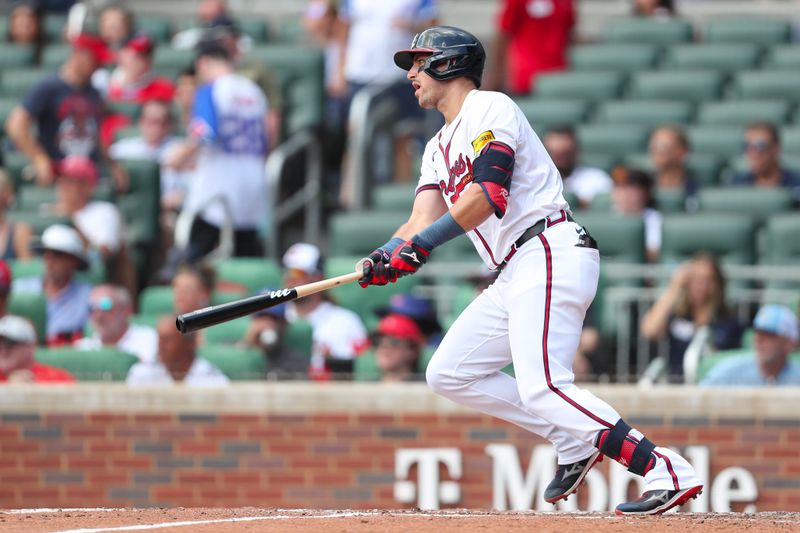 Aug 4, 2024; Cumberland, Georgia, USA; Atlanta Braves third baseman Austin Riley (27) hits a double in the third inning during the game against the Miami Marlins at Truist Park. Mandatory Credit: Mady Mertens-USA TODAY Sports