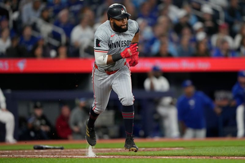 May 10, 2024; Toronto, Ontario, CAN; Minnesota Twins right fielder Manuel Margot (13) runs to first base on a single against the Toronto Blue Jays during the ninth inning at Rogers Centre. Mandatory Credit: John E. Sokolowski-USA TODAY Sports