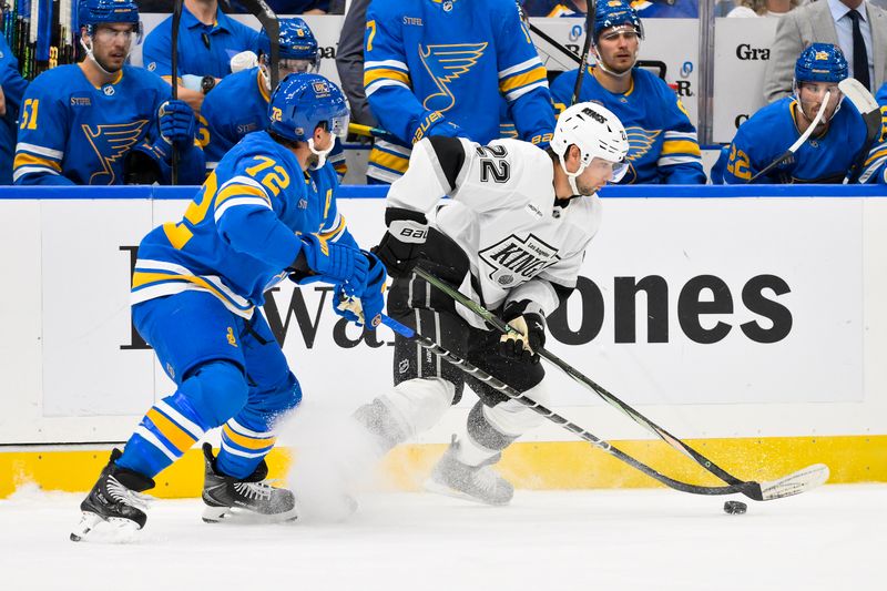 Oct 21, 2025; St. Louis, Missouri, USA; Los Angeles Kings left wing Kevin Fiala (22) controls the puck as St. Louis Blues defenseman Justin Faulk (72) defends during the first period at Enterprise Center. Mandatory Credit: Jeff Curry-Imagn Images