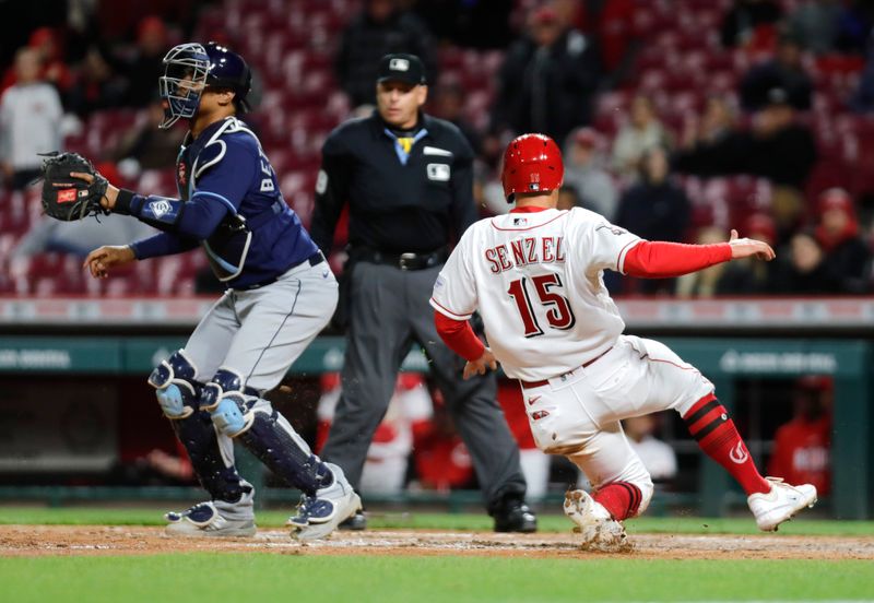 Apr 17, 2023; Cincinnati, Ohio, USA; Cincinnati Reds Nick Senzel (15) scores in front of Tampa Bay Rays catcher Christian Bethancourt (14) during the eighth inning at Great American Ball Park. Mandatory Credit: David Kohl-USA TODAY Sports