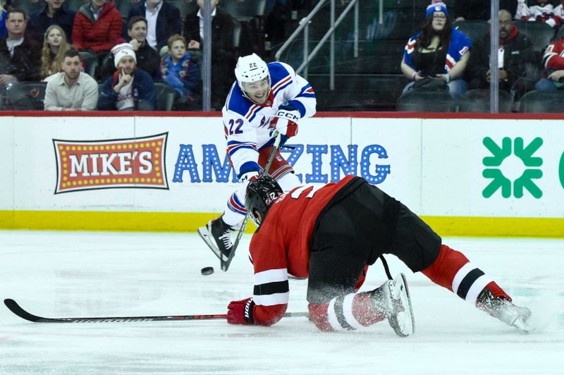 Feb 22, 2024; Newark, New Jersey, USA; New York Rangers center Jonny Brodzinski (22) shoots the puck while being defended by New Jersey Devils defenseman Brendan Smith (2) during the first period at Prudential Center. Mandatory Credit: John Jones-USA TODAY Sports