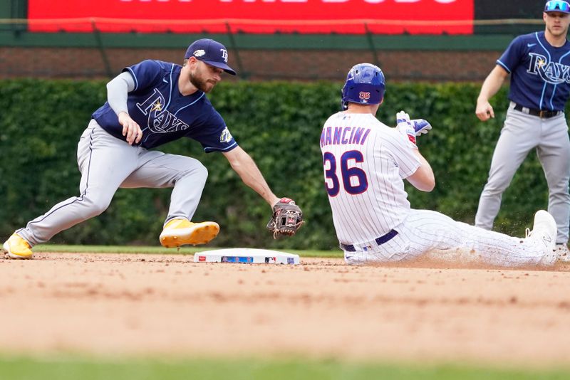 May 31, 2023; Chicago, Illinois, USA; Chicago Cubs first baseman Trey Mancini (36) is tagged out at second base by Tampa Bay Rays second baseman Brandon Lowe (8) during the seventh inning at Wrigley Field. Mandatory Credit: David Banks-USA TODAY Sports