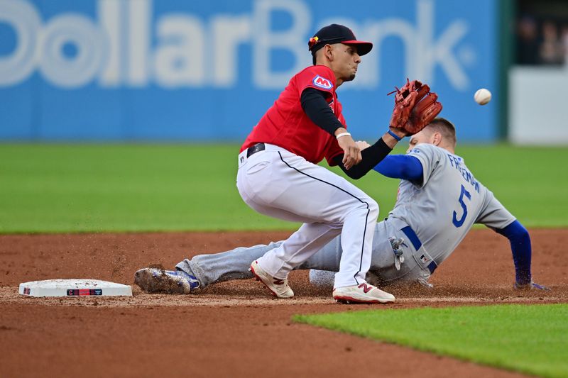 Aug 22, 2023; Cleveland, Ohio, USA; Los Angeles Dodgers first baseman Freddie Freeman (5) steals second as Cleveland Guardians second baseman Andres Gimenez (0) waits for the throw during the third inning at Progressive Field. Mandatory Credit: Ken Blaze-USA TODAY Sports