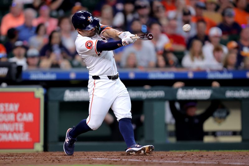 Jun 26, 2024; Houston, Texas, USA; Houston Astros second baseman Jose Altuve (27) hits a single against the Colorado Rockies during the fourth inning at Minute Maid Park. Mandatory Credit: Erik Williams-USA TODAY Sports
