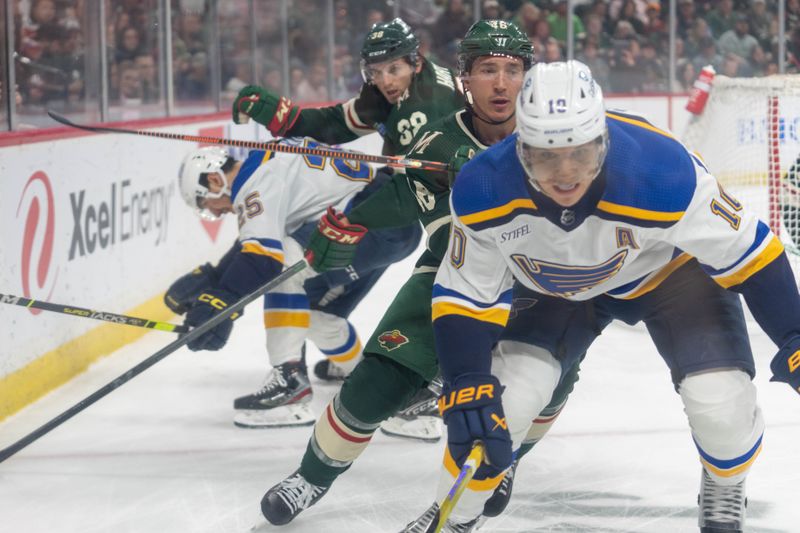 Apr 8, 2023; Saint Paul, Minnesota, USA; St. Louis Blues center Brayden Schenn (10) is chased by Minnesota Wild defenseman Jared Spurgeon (46) and right wing Ryan Hartman (38) in the first period at Xcel Energy Center. Mandatory Credit: Matt Blewett-USA TODAY Sports