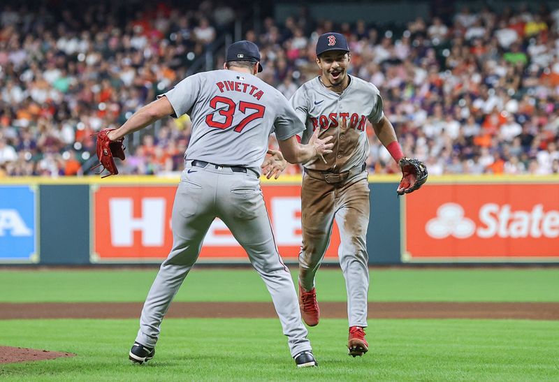 Aug 20, 2024; Houston, Texas, USA; Boston Red Sox starting pitcher Nick Pivetta (37) and second baseman David Hamilton (70) react after a play during the fourth inning against the Houston Astros at Minute Maid Park. Mandatory Credit: Troy Taormina-USA TODAY Sports