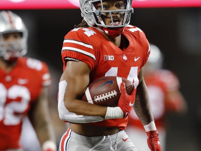 Sep 25, 2021; Columbus, Ohio, USA; Ohio State Buckeyes safety Ronnie Hickman (14)gets the interception and runs it in for the touchdown during the second quarter against the Akron Zips at Ohio Stadium. Mandatory Credit: Joseph Maiorana-USA TODAY Sports