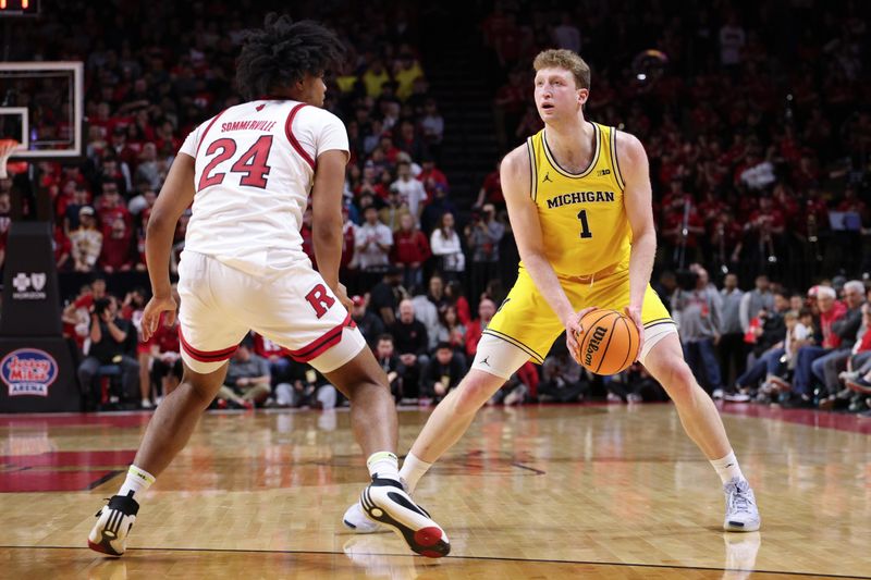 Feb 1, 2025; Piscataway, New Jersey, USA; Michigan Wolverines center Danny Wolf (1) looks to the basket  as Rutgers Scarlet Knights center Lathan Sommerville (24) defends during the first half at Jersey Mike's Arena. Mandatory Credit: Vincent Carchietta-Imagn Images