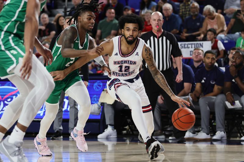 Jan 28, 2024; Boca Raton, Florida, USA; Florida Atlantic Owls guard Jalen Gaffney (12) drives to the basket past North Texas Mean Green guard Jason Edwards (2) during the second half at Eleanor R. Baldwin Arena. Mandatory Credit: Sam Navarro-USA TODAY Sports