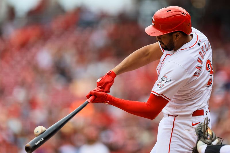 May 9, 2024; Cincinnati, Ohio, USA; Cincinnati Reds third baseman Jeimer Candelario (3) hits a solo home run in the fifth inning against the Arizona Diamondbacks at Great American Ball Park. Mandatory Credit: Katie Stratman-USA TODAY Sports