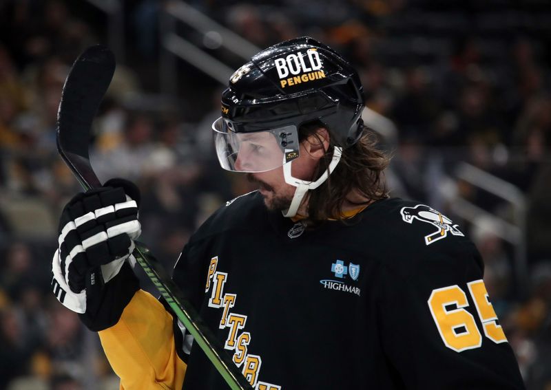 Dec 3, 2024; Pittsburgh, Pennsylvania, USA;  Pittsburgh Penguins defenseman Erik Karlsson (65) checks his stick against the Florida Panthers during the second period at PPG Paints Arena. Mandatory Credit: Charles LeClaire-Imagn Images