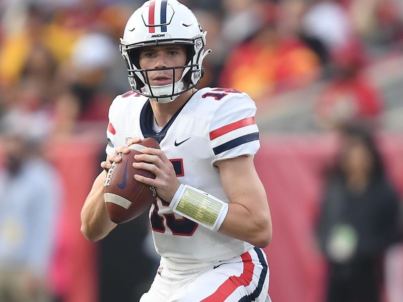 Oct 30, 2021; Los Angeles, California, USA; Arizona Wildcats quarterback Will Plummer (15) drops back to pass against the Southern California Trojans during the first half at United Airlines Field at Los Angeles Memorial Coliseum. Mandatory Credit: Gary A. Vasquez-USA TODAY Sports