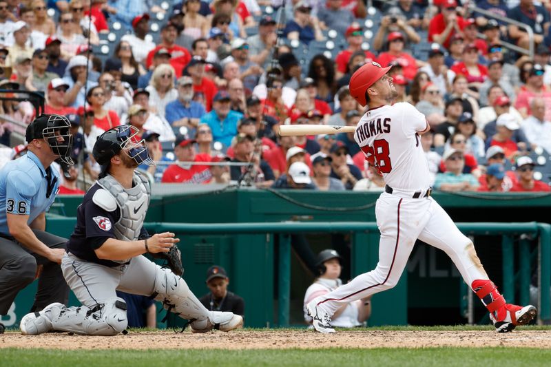 Apr 16, 2023; Washington, District of Columbia, USA; Washington Nationals right fielder Lane Thomas (28) hits an RBI sacrifice fly against the Cleveland Guardians during the eighth inning at Nationals Park. Mandatory Credit: Geoff Burke-USA TODAY Sports