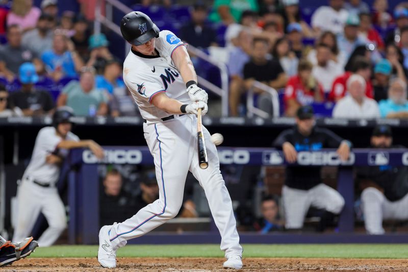 Jul 30, 2023; Miami, Florida, USA; Miami Marlins designated hitter Garrett Cooper (26) hits a two-run home run against the Detroit Tigers during the seventh inning at loanDepot Park. Mandatory Credit: Sam Navarro-USA TODAY Sports