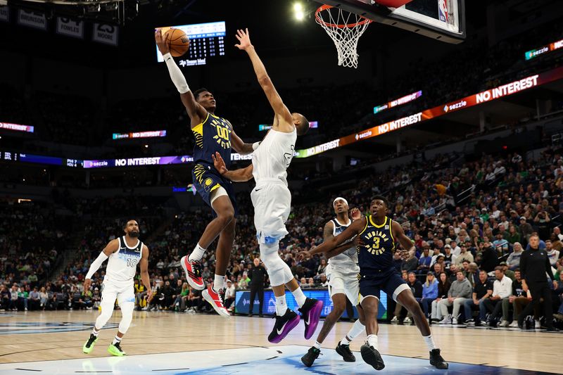 MINNEAPOLIS, MINNESOTA - MARCH 17: Bennedict Mathurin #00 of the Indiana Pacers goes up for a shot against Rudy Gobert #27 of the Minnesota Timberwolves in the first quarter at Target Center on March 17, 2025 in Minneapolis, Minnesota. NOTE TO USER: User expressly acknowledges and agrees that, by downloading and or using this photograph, User is consenting to the terms and conditions of the Getty Images License Agreement. (Photo by David Berding/Getty Images)