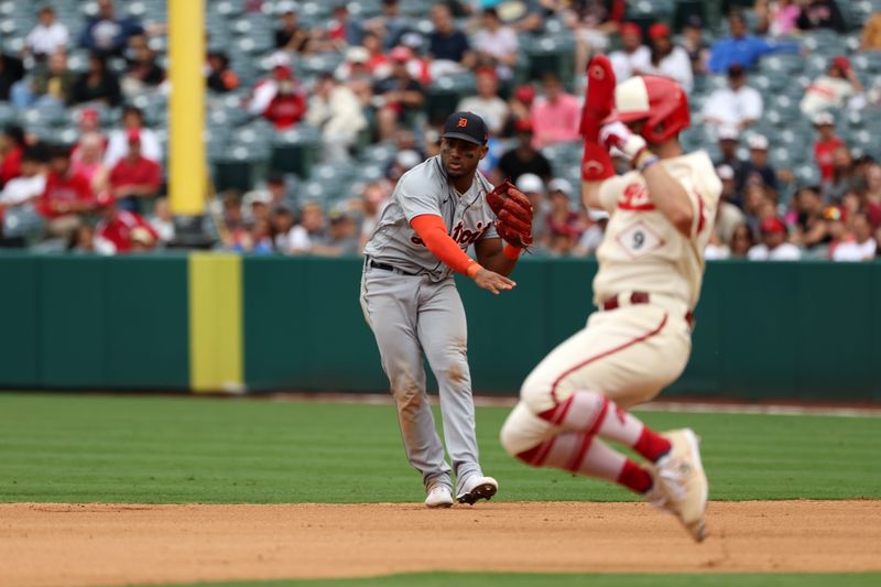 Sep 17, 2023; Anaheim, California, USA; Detroit Tigers second baseman Andy Ibanez (77) throws a ball to second as Los Angeles Angels shortstop Zach Neto (9) slides during the MLB game at Angel Stadium. Mandatory Credit: Kiyoshi Mio-USA TODAY Sports