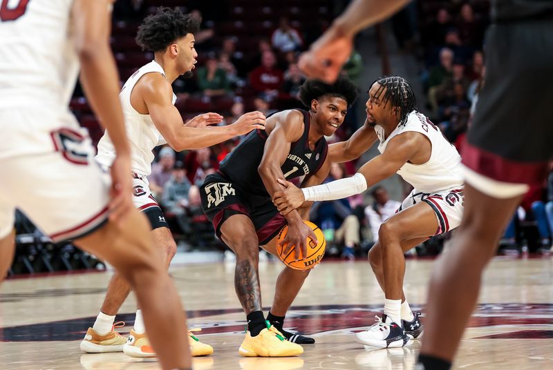 Jan 14, 2023; Columbia, South Carolina, USA; Texas A&M Aggies guard Khalen Robinson (1) loses his shoe as he is defended by South Carolina Gamecocks guard Jacobi Wright (1) and South Carolina Gamecocks guard Chico Carter Jr. (2) in the second half at Colonial Life Arena. Mandatory Credit: Jeff Blake-USA TODAY Sports