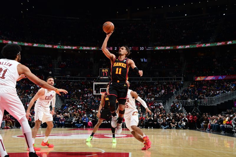 ATLANTA, GA - JANUARY 20: Trae Young #11 of the Atlanta Hawks drives to the basket during the game against the Cleveland Cavaliers on January 20, 2024 at State Farm Arena in Atlanta, Georgia.  NOTE TO USER: User expressly acknowledges and agrees that, by downloading and/or using this Photograph, user is consenting to the terms and conditions of the Getty Images License Agreement. Mandatory Copyright Notice: Copyright 2024 NBAE (Photo by Scott Cunningham/NBAE via Getty Images)