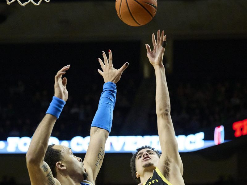 Feb 11, 2023; Eugene, Oregon, USA;  Oregon Ducks guard Will Richardson (0) shoot a basket during the first half against UCLA Bruins guard Amari Bailey (5) at Matthew Knight Arena. Mandatory Credit: Troy Wayrynen-USA TODAY Sports